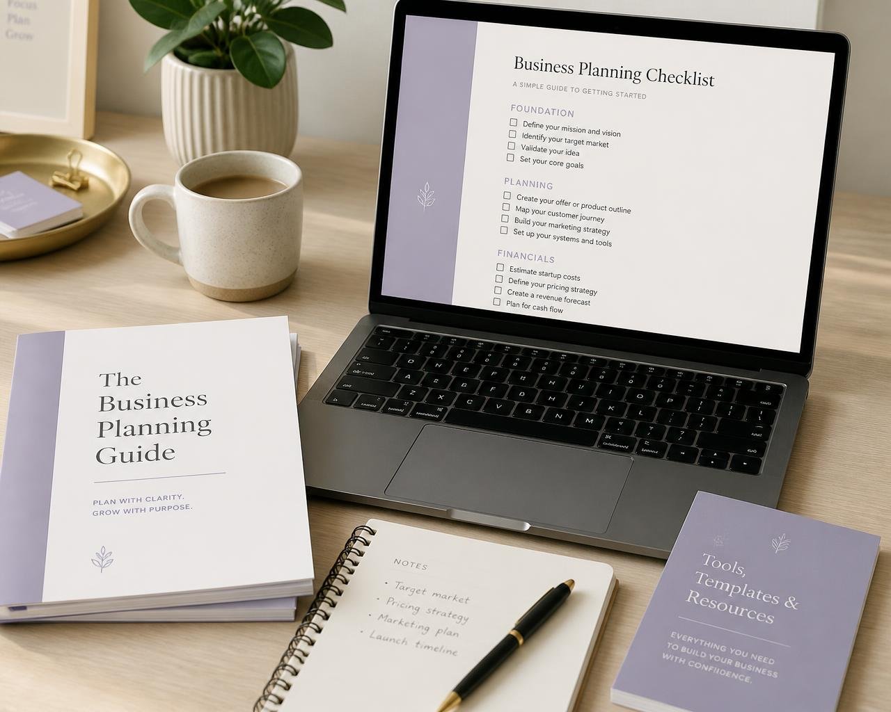 Printed Essensia guides, a checklist on a laptop and a notebook on a desk